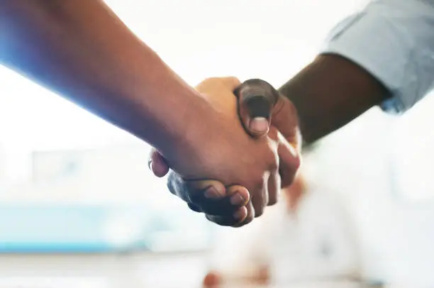 Photo of Shot of two unrecognizable businessman shaking hands