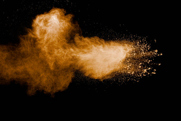 istock Abstract brown dust explosion on black background.Brown powder splashing. 1324891054