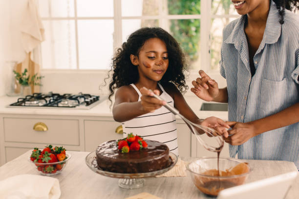 istock Girl learning to make cake with her mother 1324891115