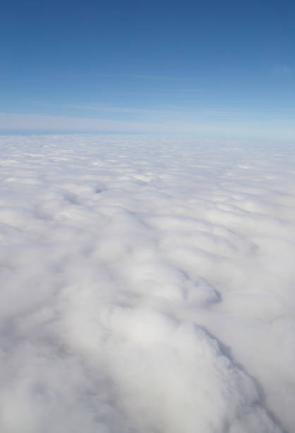 istock Aerial view of blue sky and horizon above fluffy white clouds 1324891738