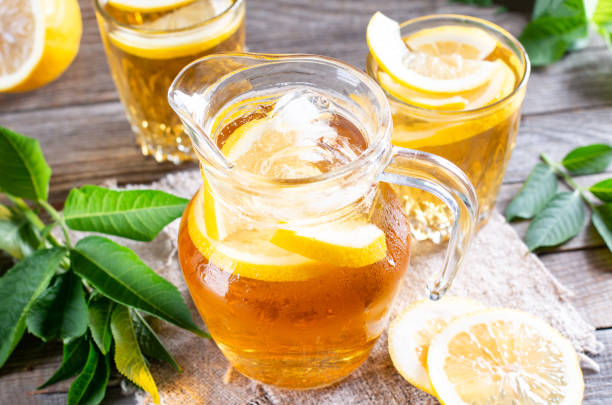 istock Glass jug of cold lemonade on table 1324893095