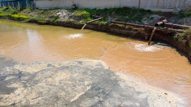 istock Waste water flows to river. Dirty water and environmental pollution. 1324893190
