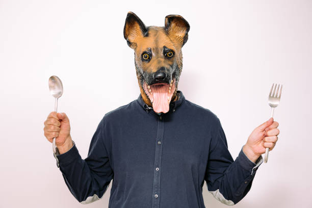istock person with dog mask showing spoon and fork 1324893537