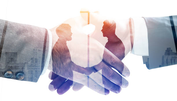 istock Business people handshake, skyscrapers and panoramic windows 1324893699