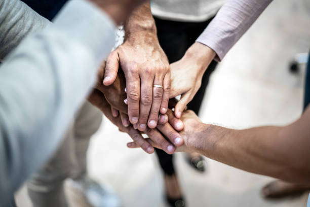 istock Group of business people stacking hands 1324893846