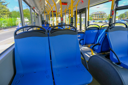 Empty blue seats in a bus close-up. Public urban transportation