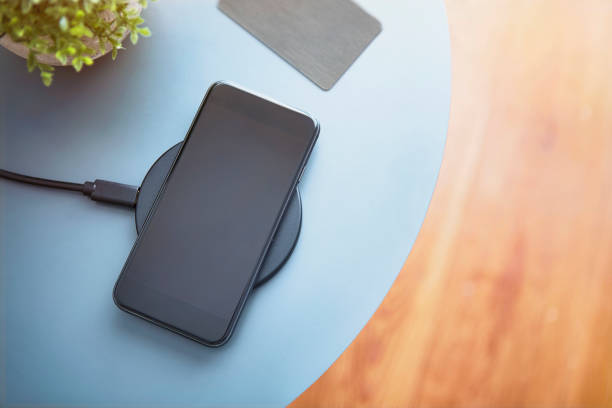 istock Modern black smartphone laying on table next to electronic chip access card. High angle view. 1324895746