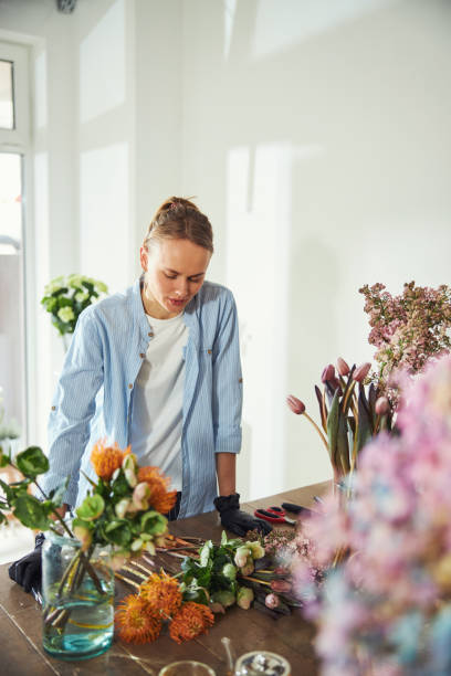 istock Concentrated floral designer staring at beautiful exotic flowers 1324895901