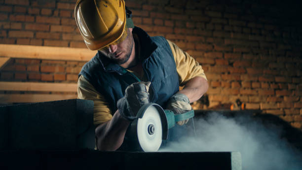 istock Adult man cutting brick wall 1324897283