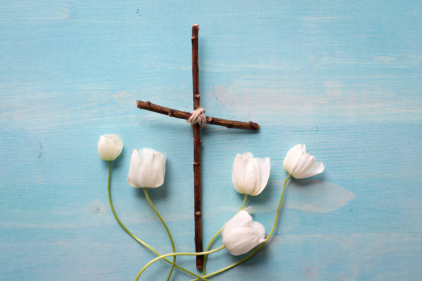 istock Wood cross and white flowers 1324897352
