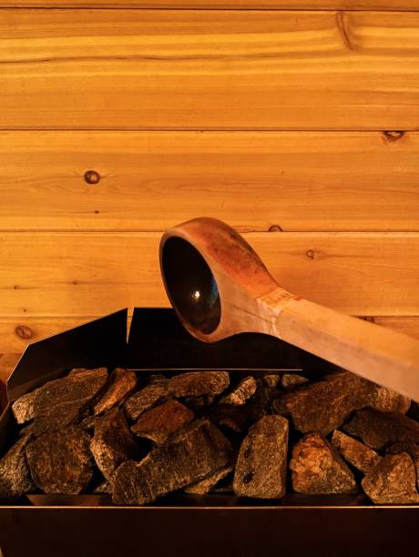 istock Large Spoon Pouring Water on Sauna Rocks 1324898161