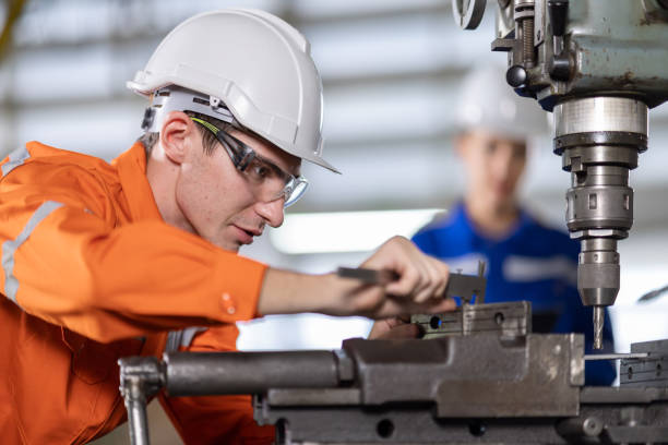 istock Quality Control Caucasian white engineers working on a drilling machine in a factory. 1324900683
