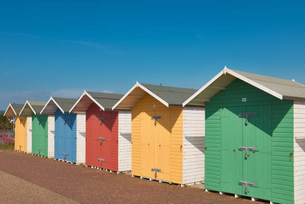 istock Brightly coloured beach huts against a clear blue sky. 1324900744