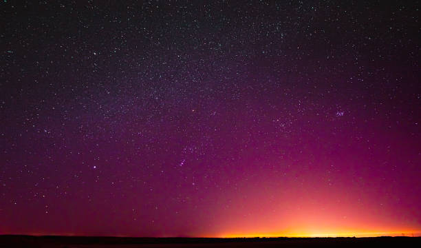 istock Night Sky Glowing Stars Background Backdrop. Colorful Sky Gradient. Sunset, Sunrise Lights And Colourful Night Starry Sky In Yellow Pink Magenta Orange Purple Colors. Dark Ground. Copy Space 1324900770