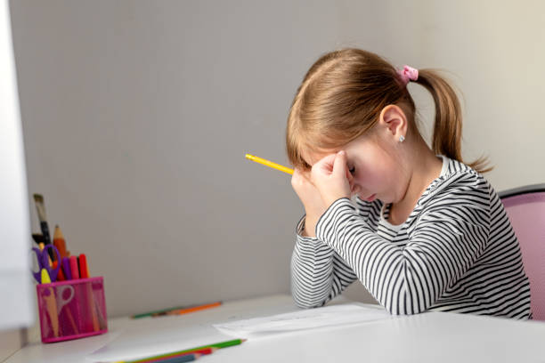 istock the girl is tired and covers her face with her hands 1324901077