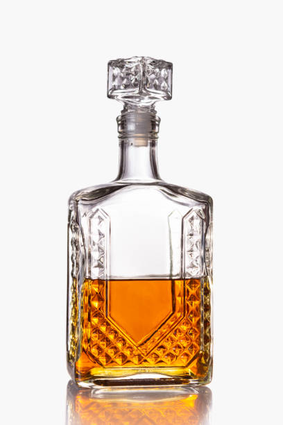 istock Glass decanter half filled with cognac or other alcoholic beverage isolated on a white background. 1324902936