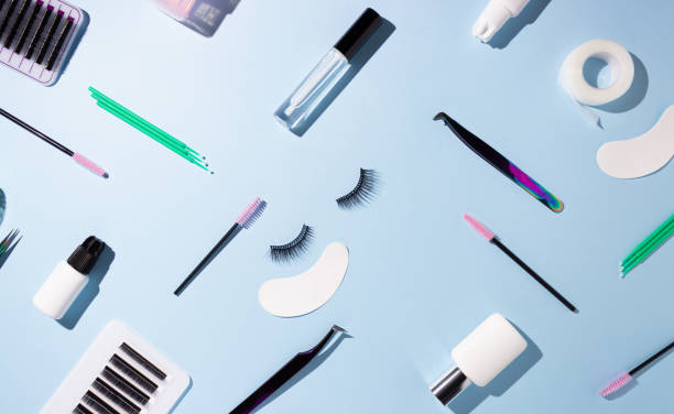 istock Tools for eyelash extension on a blue background. Artificial eyelashes, self-care. Top view. 1324902948