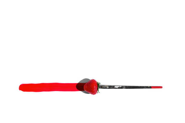 strawberries as a brush with red paint. concept summer. with copy space