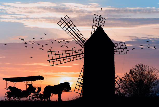istock Horse carriage in the sunset at a windmill 1324904235