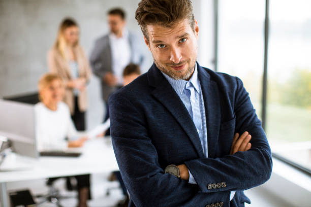 istock Handsome young business man standing confident in the office 1324904312