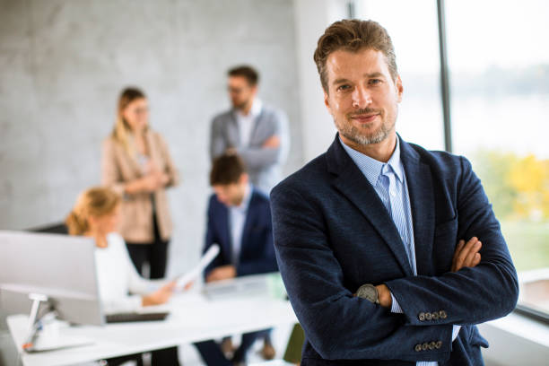 Handsome young business man standing confident in the office stock photo