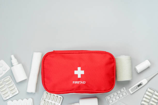 istock First aid kit red bag with medications on gray background. 1324904370