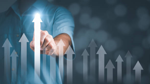 istock Businessman pointing white arrow graph corporate future growth plan. Business development to success and growth.background blurred. 1324907910