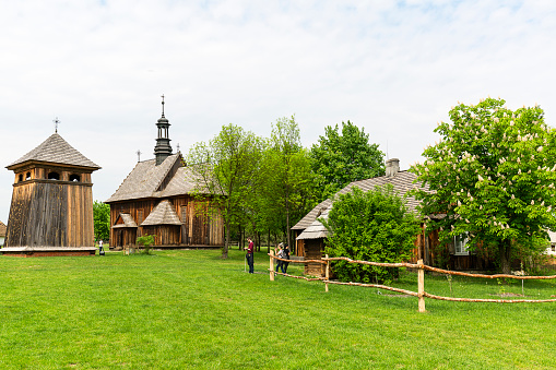 Tokarnia, Poland - May 2, 2017: 18th century wooden church in open air museum, Museum of the Kielce Village ( Muzeum Wsi Kieleckiej),  rural landscape