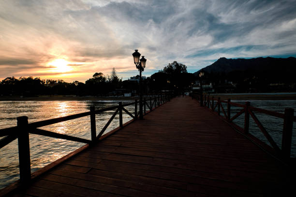 istock Sunset at the long jetty in Marbella, Costa del Sol, Spain 1324908305