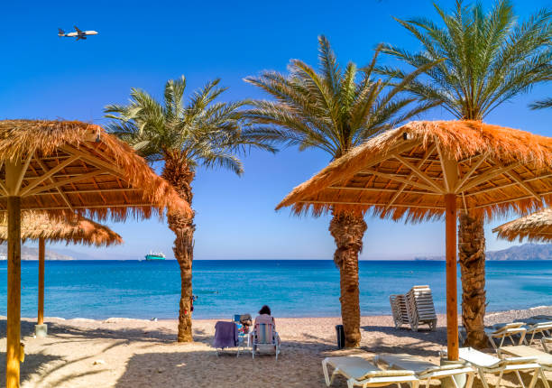 Morning on sandy beach of the Red Sea in Eilat Morning on sandy beach in Eilat - famous tourist resort and recreation city in Israel akaba stock pictures, royalty-free photos & images