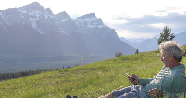 istock Hiker relaxes on grassy mountain ridge in the morning 1324910539
