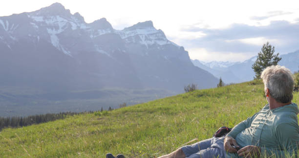 istock Hiker relaxes on grassy mountain ridge in the morning 1324911230