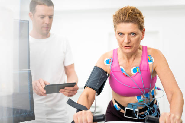 istock Doctor using digital tablet while monitoring a mature adult woman's biometric testing 1324912691
