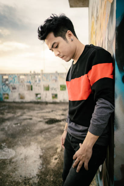 istock Handsome Man Standing in Front of graffiti wall art 1324914454