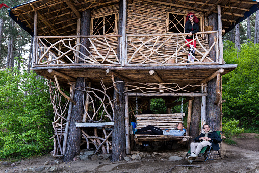 Friends are resting in a tree house.