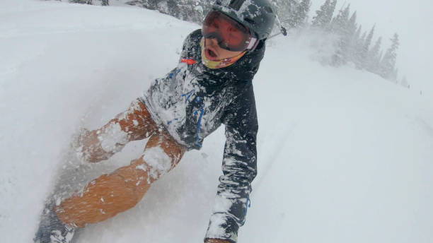POV looking backwards. Heavy snow sprays his face