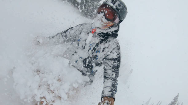 istock Skier descends snow slope through deep powder snow 1324916556