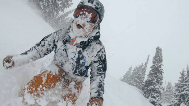 istock Skier descends snow slope through deep powder snow 1324916622