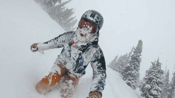 istock Skier descends snow slope through deep powder snow 1324916624