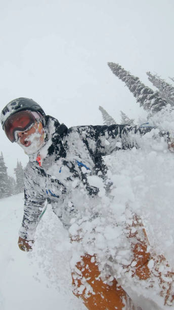 istock Skier descends snow slope through deep powder snow 1324916627
