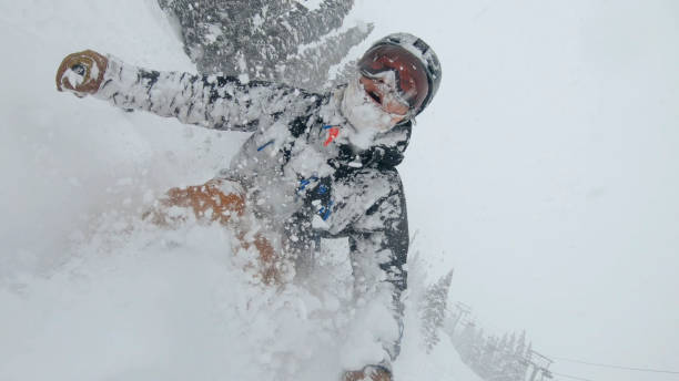 istock Skier descends snow slope through deep powder snow 1324916685