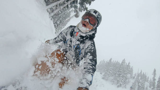 istock Skier descends snow slope through deep powder snow 1324916692