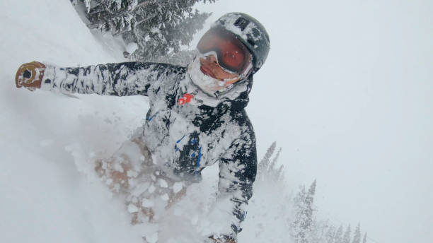 istock Skier descends snow slope through deep powder snow 1324916699