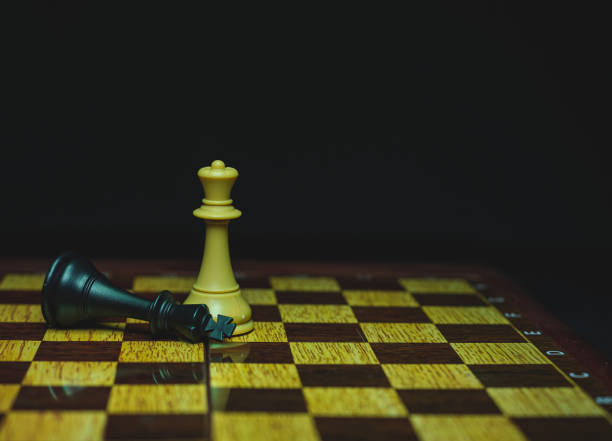 istock chess piece, white queen beats black king, on board 1324916919