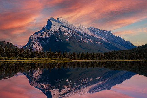 Beautiful golden sunset on Vermillion Lakes in the Canadian Rockies of Banff National Park, Alberta, Canada, with Mount Rundle reflecting on the calm waters.
