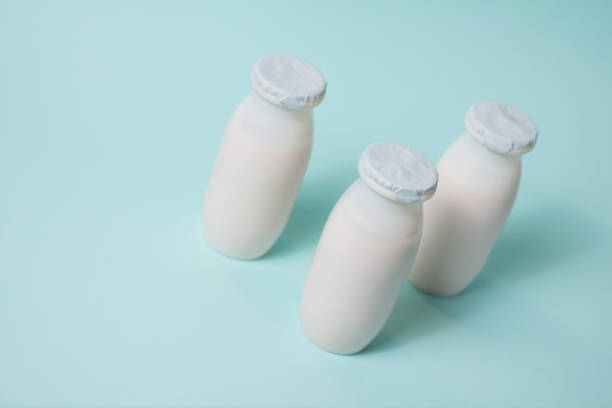 istock Bottles with probiotics and prebiotics dairy drink on light blue background. 1324920563