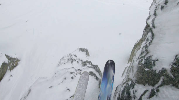 istock POV as skier prepares to drop off cliff on mountain ridge 1324921241