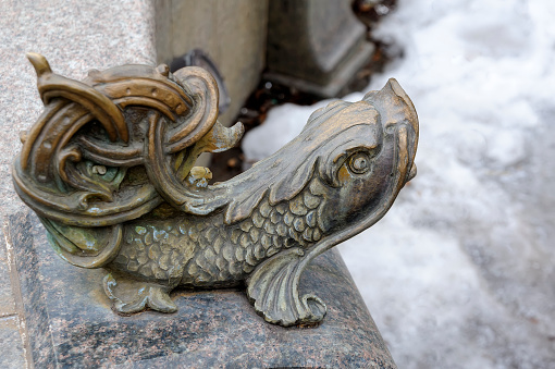 Closeup of the ornate fish water cannon on fountain in Kyiv Ukraine