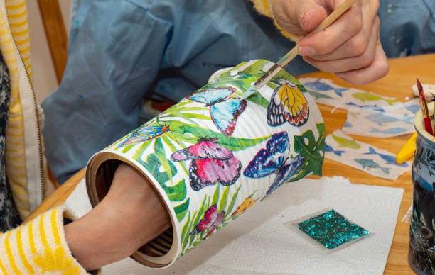 Arts and crafts decoupage with kids Women is applying lacquer to an Arts and crafts decoupage project using napkins with kids decoupage stock pictures, royalty-free photos & images