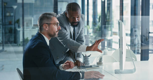 istock Shot of two mature businessmen working together on a computer in an office 1324924309